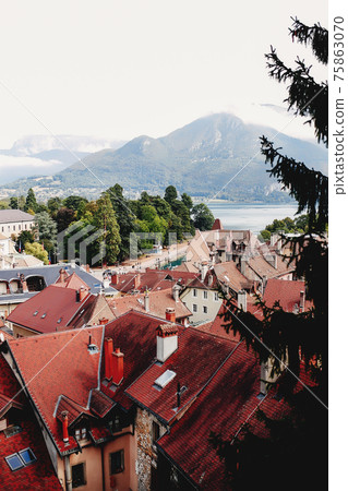 Annecy city top view, lake in the distance. Tile roofs, Cathedral Annecy city top view, lake in the distance. Tile roofs, Cathedral 75863070