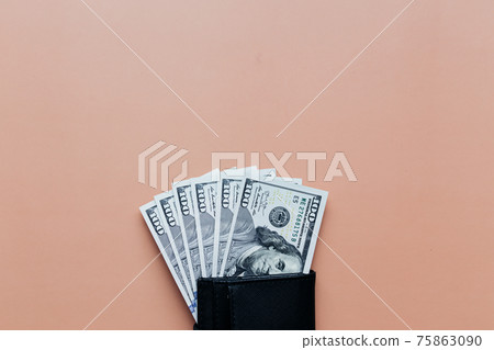 Bundle of dollars in purse on beige background 75863090