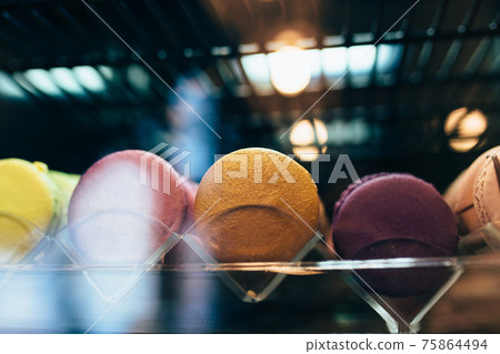 Multicolored macarons on a showcase in a cafe 75864494