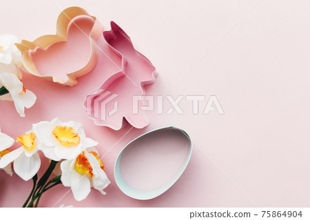 Spring Narcissus, bunny, egg, bird Easter form for baking. Pink background Spring Narcissus, bunny, egg, bird Easter form for baking. Pink background 75864904