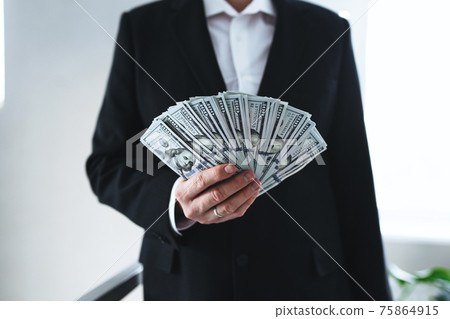 One hundred dollar bills money fun, in hand of man in suit and white shirt 75864915
