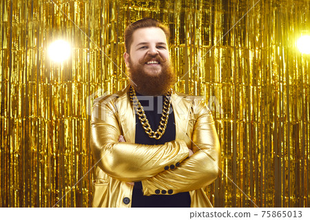Portrait of happy man in shiny golden disco jacket standing arms folded and smiling Portrait of happy man in shiny golden disco jacket standing arms folded and smiling 75865013