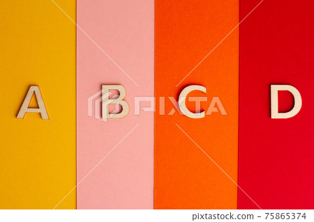 A B C and D letters of the alphabet on colored paper background A B C and D letters of the alphabet on colored paper background 75865374