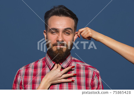 Half-length portrait of young Caucasian man isolated over blue background. Half-length portrait of young Caucasian man isolated over blue background. 75865428