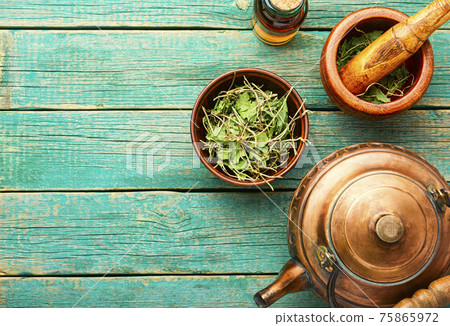 Orthilia secunda,healing herbs on wooden table 75865972