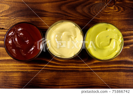 Set of sauces on wooden table Set of sauces on wooden table 75866742