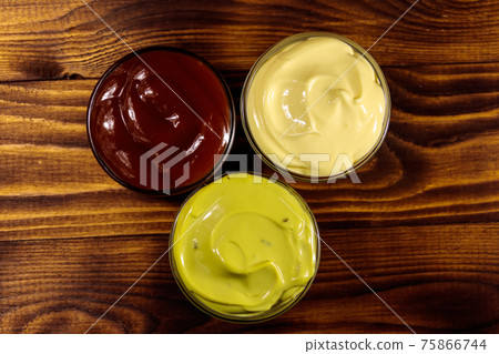Set of sauces on wooden table Set of sauces on wooden table 75866744