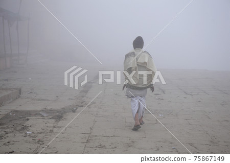 Foreign man walking in the fog 75867149