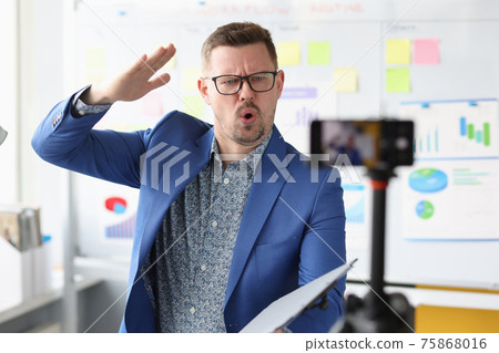 Business coach telling information into mobile phone camera Business coach telling information into mobile phone camera 75868016
