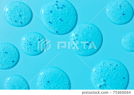 Clear gel cleanser spots on blue background 75868084