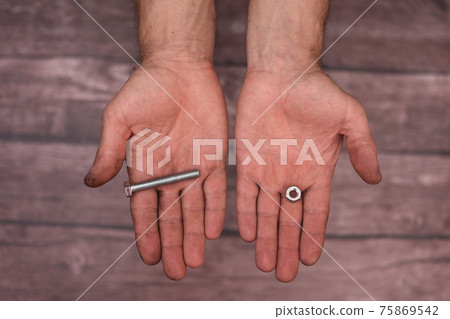 In the men's hands are a bolt and a nut.  75869542