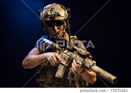 Special forces soldier with rifle on black background 75870261