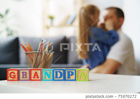 Grandfather and granddaughter playing together at home 75870272