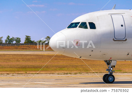 Cockpit of big passenger airliner on runway close up Cockpit of big passenger airliner on runway close up 75870302