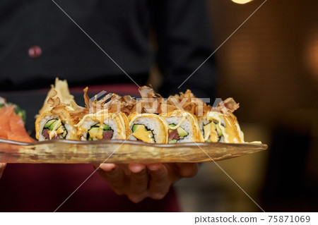 Close-up photo of appetizing set of sushi on plate Close-up photo of appetizing set of sushi on plate 75871069