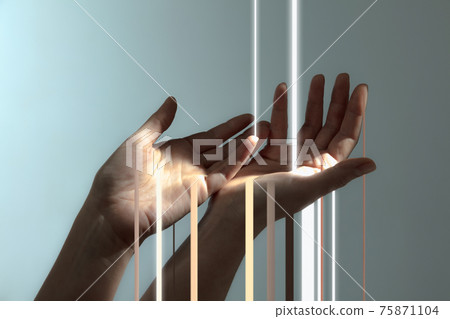 Light rays passing through human hands isolated on light grey background. 75871104