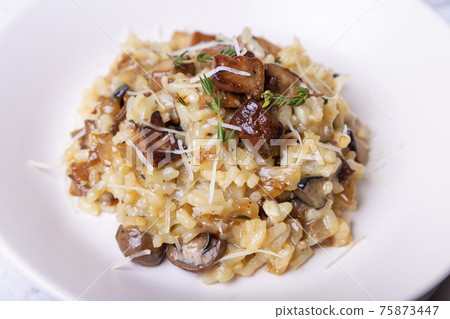 Risotto with porcini mushrooms. Traditional Italian dish. Close-up, horizontal orientation. Risotto with porcini mushrooms. Traditional Italian dish. Close-up, horizontal orientation. 75873447