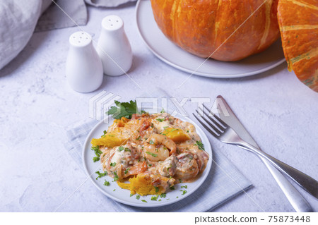 Pumpkin stuffed with shrimps and cheese, whole baked. Traditional Brazilian dish. Close-up. Pumpkin stuffed with shrimps and cheese, whole baked. Traditional Brazilian dish. Close-up. 75873448
