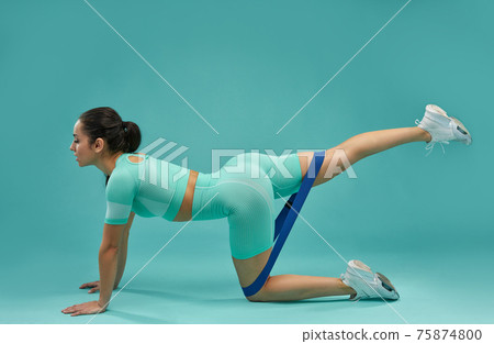 Sporty young woman working out with fitness band Sporty young woman working out with fitness band 75874800
