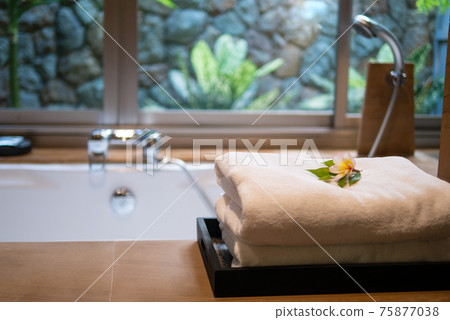 Towels on bath tub in resort hotel bathroom for spa skin care hospitality on holiday vacation Towels on bath tub in resort hotel bathroom for spa skin care hospitality on holiday vacation 75877038