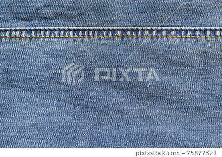 Denim fabric with full frame stitching. Blue jeans cloth with seam. Background texture. Denim fabric with full frame stitching. Blue jeans cloth with seam. Background texture. 75877321