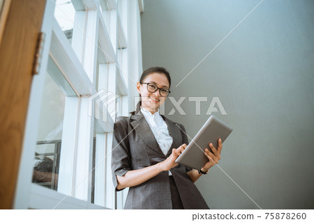 Portrait of young beautiful businesswoman holding tablet Portrait of young beautiful businesswoman holding tablet 75878260