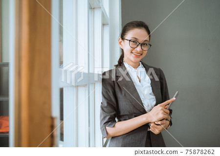 Portrait of young beautiful businesswoman holding tablet Portrait of young beautiful businesswoman holding tablet 75878262
