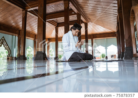 Muslim man kneel down worship and prays for Allah in Muslim man kneel down worship and prays for Allah in 75878357