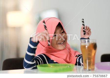happy muslim girl are playing breakfast dessert 75878667