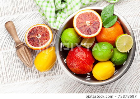 Various fresh citrus fruits in colander. Bood orange, lime, lemon 75878697