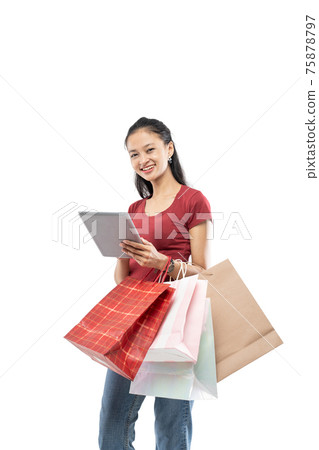 Beautiful woman holding a shopping bag and tablet with smile expression Beautiful woman holding a shopping bag and tablet with smile expression 75878797