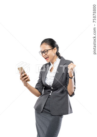 Beautiful businesswoman holding and look handphone with happiness expression Beautiful businesswoman holding and look handphone with happiness expression 75878800