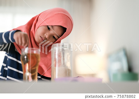 muslim kid girl are make tea drink muslim kid girl are make tea drink 75878802