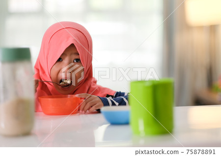 muslim little girl are having breakfast 75878891