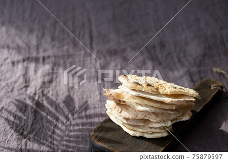 Homemade matzo with microgreen peas. Unleavened flatbread bread. Pesah celebration concept. Jewish Passover background. Pita. 75879597