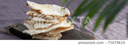 Homemade matzo with microgreen peas. Unleavened flatbread bread. Pesah celebration concept. Jewish Passover background. Pita. 75879610