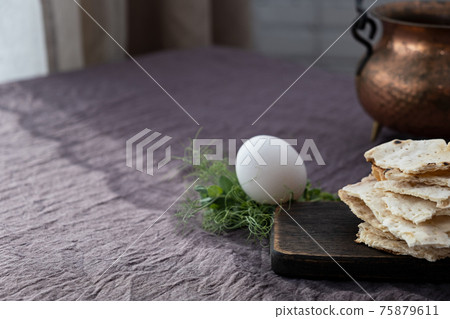 Homemade matzo with microgreen peas. Unleavened flatbread bread. Pesah celebration concept. Jewish Passover background. Pita. Homemade matzo with microgreen peas. Unleavened flatbread bread. Pesah celebration concept. Jewish Passover background. Pita. 75879611