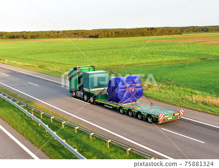 Truck driving along highway on blue sky background.  75881324