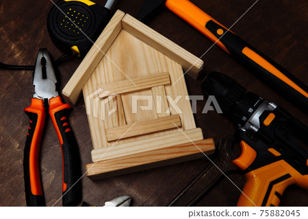 Various repair tools and model of house close-up. Equipment for building Various repair tools and model of house close-up. Equipment for building 75882045