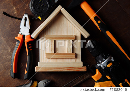 House repair with many tools on a wooden table. Close-up House repair with many tools on a wooden table. Close-up 75882046