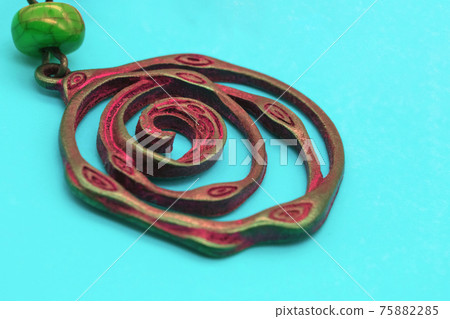 Ethnic decorations on colored sheets of paper. 75882285