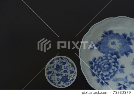 Antique Imari ware ceramics. Layout of picture plate on black background (copy space, soft focus) Antique Imari ware ceramics. Layout of picture plate on black background (copy space, soft focus) 75883579