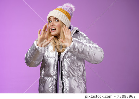 Afraid intense uncomfortable young fair-haired woman in winter hat silver stylish dress run away raise hands self-defense turn head away scared friend spill drink new outfit, purple background Afraid intense uncomfortable young fair-haired woman in winter hat silver stylish dress run away raise hands self-defense turn head away scared friend spill drink new outfit, purple background 75885962