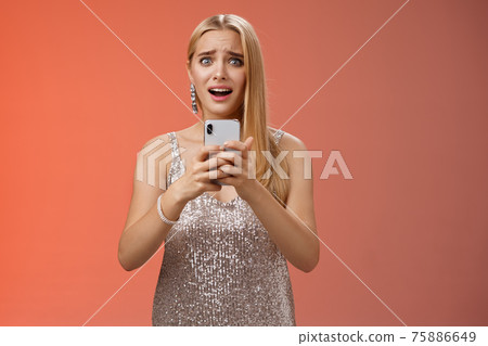 Panicking shocked woman concerned photos leaked internet look afraid anxious widen eyes cringing troubled hold smartphone shook speechless gasping terrified friends find out secret, red background 75886649