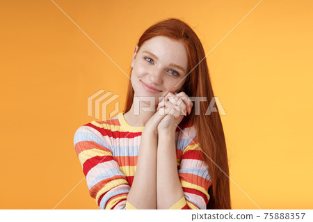 Dreamy sensual romantic young passionate redhead girlfriend melt heart feel sympathy joy receive sweet tender present lean palms smiling grateful gladly accept nice lovely gift, orange background Dreamy sensual romantic young passionate redhead girlfriend melt heart feel sympathy joy receive sweet tender present lean palms smiling grateful gladly accept nice lovely gift, orange background 75888357