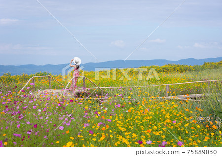 Beautiful woman in nature flower. 75889030