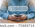 The man use smartphones to find what he is interested. Searching information data on internet 75889714