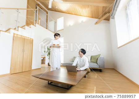 A man teleworking in the atrium living room A man teleworking in the atrium living room 75889957