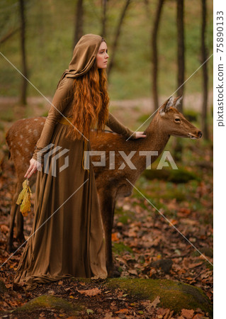 Redhead girl with deer in a long dress Redhead girl with deer in a long dress 75890133