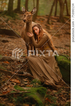 Redhead girl with deer in a long dress 75890134